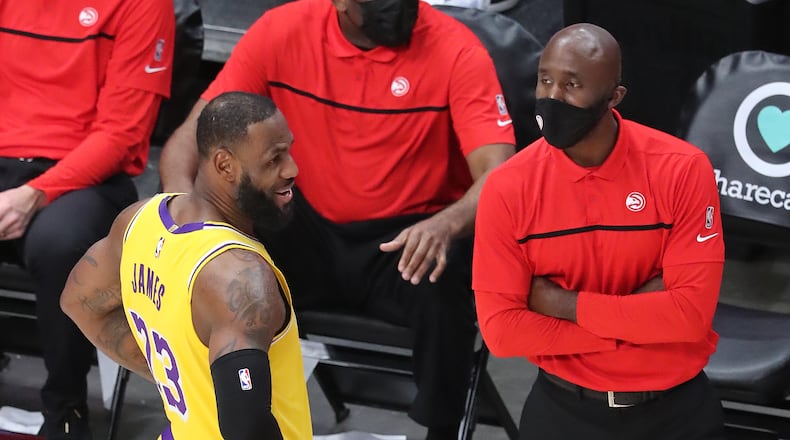 Hawks, Lakers meet at State Farm Arena: Hawks head coach Lloyd Pierce and Lakers star LeBron James share a light moment during Monday's game in Atlanta.