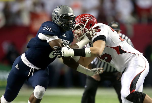 Defensive end for Norcross, Lorenzo Carter (left) was selected was an AJC Super 11 player in 2013. (Jason Getz/AJC)
