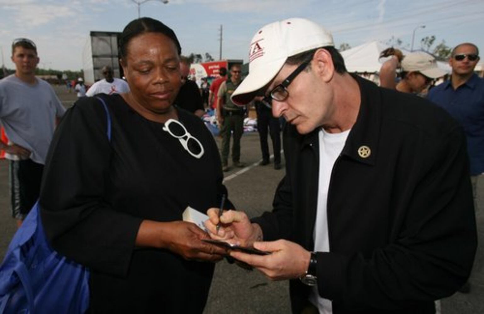 Charlie Sheen tours tornado damage in Alabama