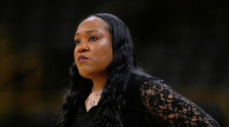 FILE - Virginia head coach Amaka Agugua-Hamilton watches from the bench during the first half in a First Four college basketball game against Arizona State in the NCAA Tournament, March 19, 2026, in Iowa City, Iowa. (AP Photo/Charlie Neibergall, File)