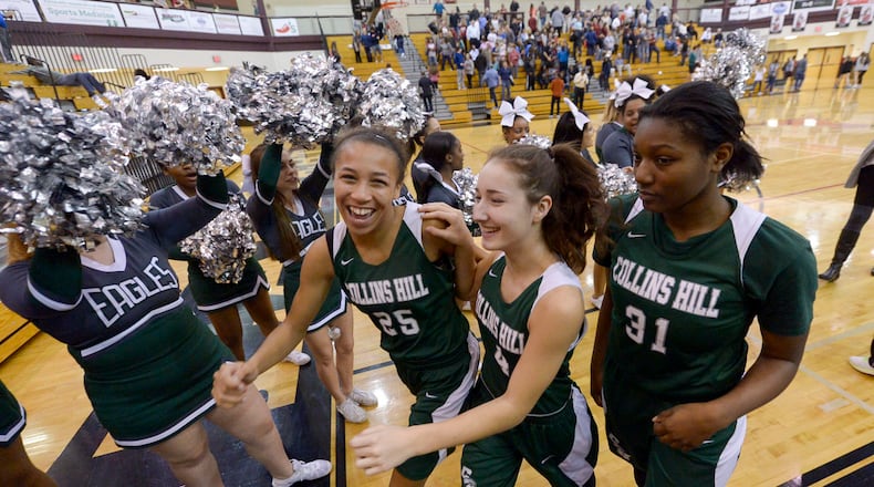 Collins Hill freshman Savannah Samuels (25), sophomore Claire Starjevich (4), and junior Jada Rice (31) celebrate their win over Lambert in a quarterfinal basketball game at Lambert High School on Tuesday. SPECIAL/Daniel Varnado