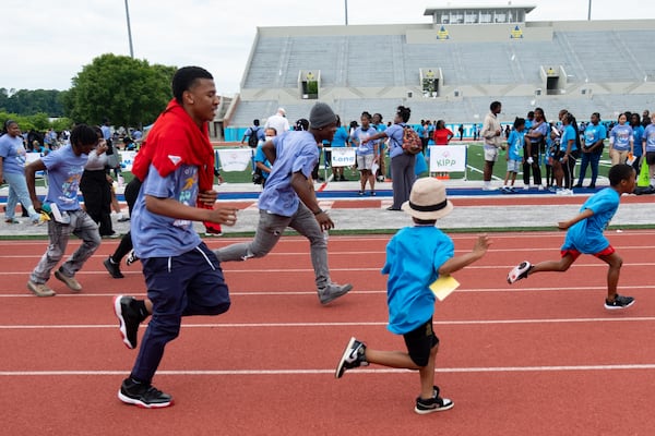 Students and volunteers race during the Atlanta Public Schools Special Olympics at Lakewood Stadium on Wednesday. (Ben Gray for the AJC)