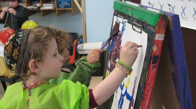 Eli Bendicoff (foreground) and Levi Frank work on their artistic creations at the Alefbet Preschool in Dunwoody. A gallery of student work will be on display during an art exhibition on March 31.