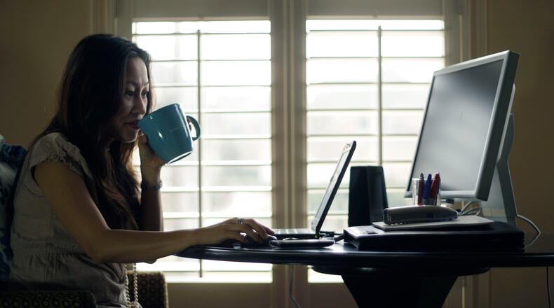 Denise Kenson-Liu works from her Snellville home one day a week for her job with the IT department of Gwinnett County on Fri, Feb.18, 2011. Bob Andres bandres@ajc.com