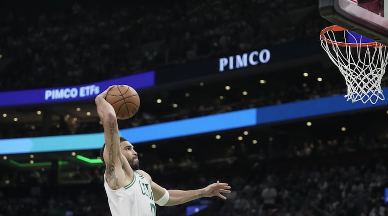 Boston Celtics forward Jayson Tatum goes in for a dunk against the Philadelphia 76ers during the first half in Game 1 of a first-round NBA playoffs basketball game, Sunday, April 19, 2026, in Boston. (AP Photo/Robert F. Bukaty)
