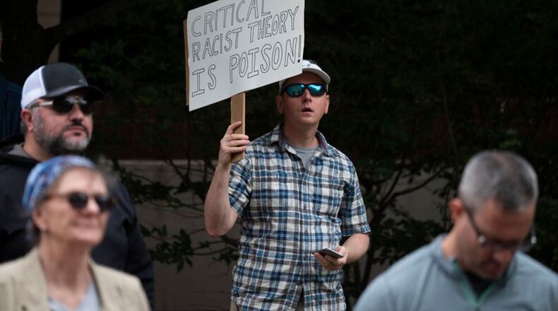 A man holds up a sign during a rally against "critical race theory" (CRT) being taught in schools at the Loudoun County Government center in Leesburg, Va., on June 12, 2021. (Andrew Caballero-Reynolds/AFP via Getty Images/TNS)