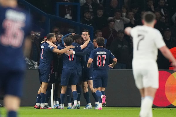 PSG players celebrate after Khvicha Kvaratskhelia scored their second goal during the Champions League quarterfinal first leg soccer match between Paris Saint-Germain and Aston Villa at Parc des Princes stadium in Paris, Wednesday, April 9, 2025. (AP Photo/Aurelien Morissard)
