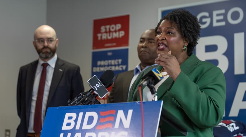 Left to right - State Senator, Josh McLaurin, Chair of the Democratic National Committee, Jaime Harrison, listen to leader, Stacey Abrams during a post presidential debate press conference at at the Biden-Harris campaign office located at 274 Decatur Street SE in Atlanta, one of several in the city. (John Spink/AJC)