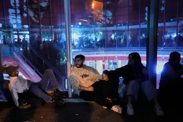 People gather in Atocha train station during a major power outage in Madrid, Monday, April 28, 2025. (AP Photo/Manu Fernandez)