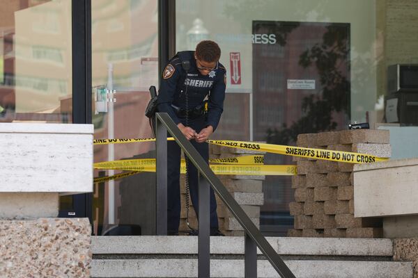 Law enforcement work outside the Family Law Center after a Harris County deputy was shot in Houston, Monday, April 21, 2025. (Yi-Chin Lee/Houston Chronicle via AP)