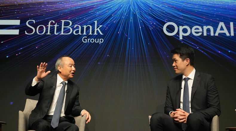Masayoshi Son, left, chairman and CEO of SoftBank Group, speaks as Mark Chen, chief research officer for OpenAI, listens during a talk at their business event at a hotel in Tokyo, Tuesday, June 16, 2026. (AP Photo/Hiro Komae)