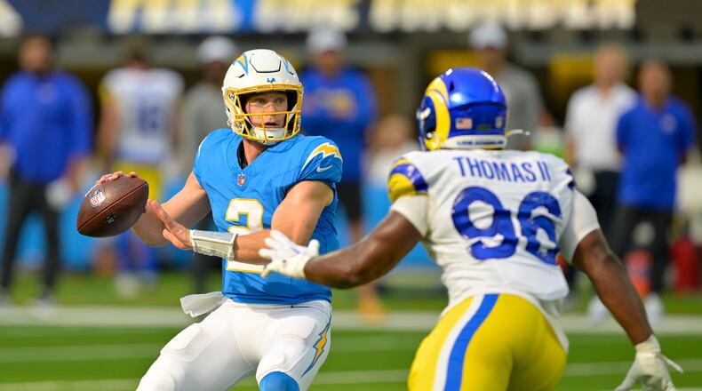 Los Angeles Chargers quarterback Easton Stick (2) throws under pressure from Los Angeles Rams linebacker Keir Thomas (96) during the first half of a preseason NFL football game Aug. 17, 2024, in Inglewood, California. (Jayne Kamin-Oncea/AP)