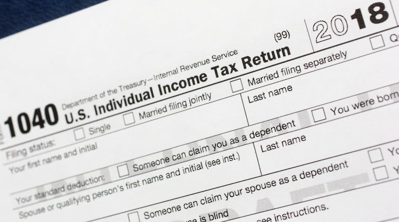 Most taxpayers got a tax cut last year, but when they file their returns they may find themselves with less of a refund check — or even owing the government money. (AP Photo/Mark Lennihan, File)