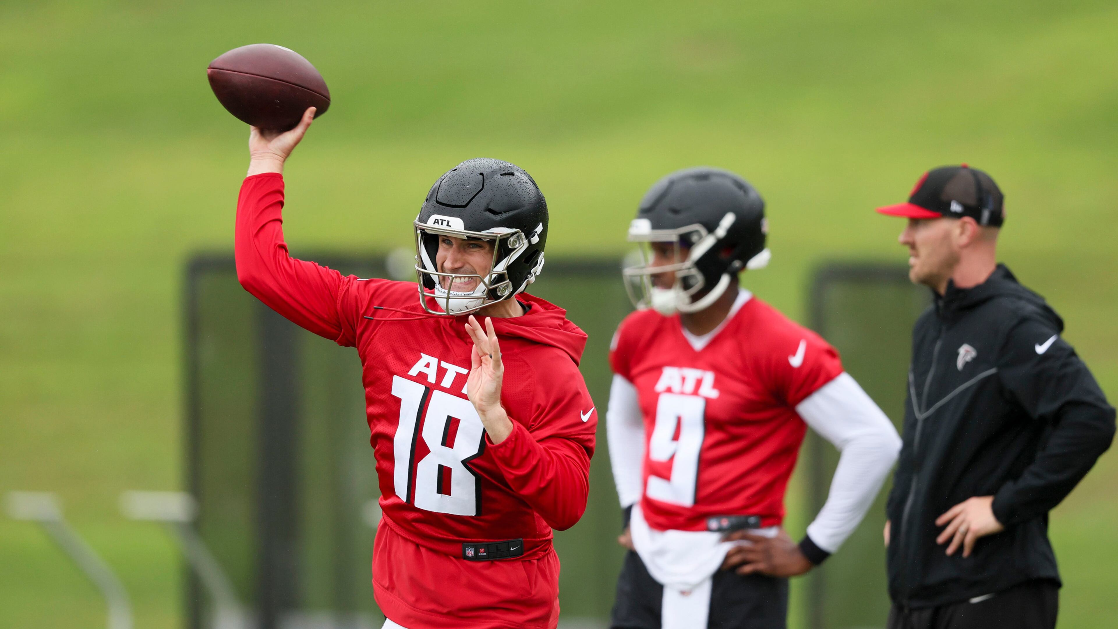 Atlanta Falcons quarterback Kirk Cousins (left) attempts a pass next to quarterback Michael Penix Jr. during minicamp at the Atlanta Falcons Training Camp, in Flowery Branch. (Jason Getz/TNS/AJC 2024)