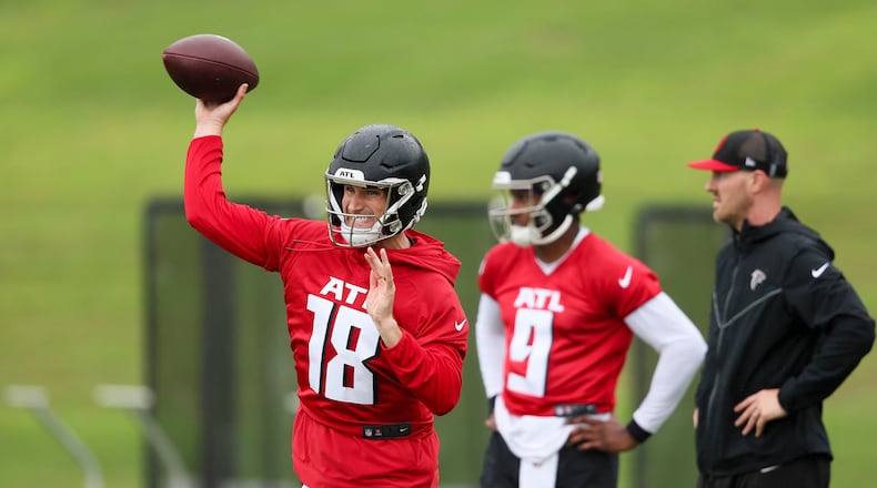 Atlanta Falcons quarterback Kirk Cousins (18) attempts a pass next to quarterback Michael Penix Jr. (9) during minicamp at the Atlanta Falcons Training Camp, Tuesday, May 14, 2024, in Flowery Branch, Georgia. (Jason Getz/The Atlanta Journal-Constitution/TNS)