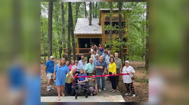 Members of Friends of Newton Parks, the Newtown County Chamber of Commerce and supporters of Chimney Park prepare to cut the ribbon on the park's new universally accessible treehouse. (Photo provided by Alice Queen)