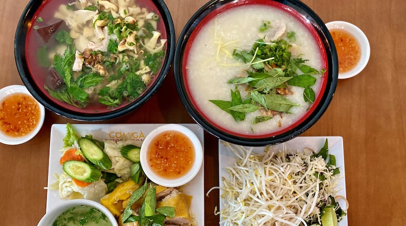 This meal at Duluth’s Com Ga Houston includes bun mang, duck congee, fresh herbs and bean sprouts for garnishing the bowls, and com ga (chicken with rice). Wendell Brock for The Atlanta Journal-Constitution