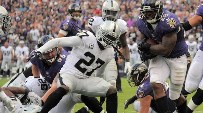 Baltimore Ravens running back Terrance West (28) runs into the end zone past Oakland Raiders free safety Reggie Nelson (27) during the fourth quarter on Sunday, Oct. 2, 2016 in Baltimore, Md. (Karl Merton Ferron/Baltimore Sun/TNS)