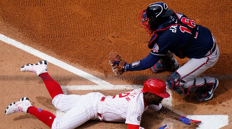 Andrew McCutchen scores past Braves catcher Travis d'Arnaud during the first inning of Thursday's Phillies-Braves game in Philadelphia.