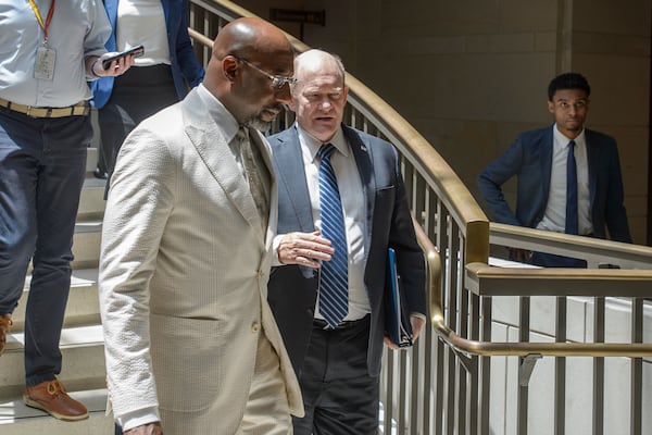 U.S. Sens. Raphael Warnock, D-Ga., (left), and Chris Coons, D-Del., chatted on their way to a briefing at the Capitol last week. 
