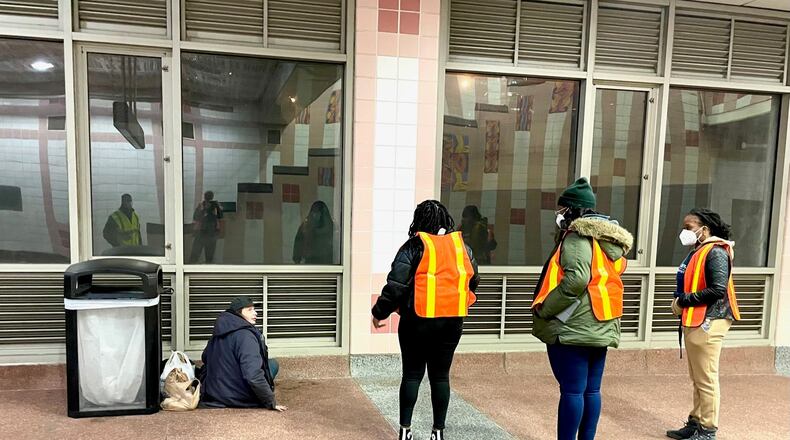 Volunteers conducting the annual point-in-time count of homeless people in Atlanta interact with Jerry Young at MARTA's Buckhead Station. (Photo by Bill Torpy)