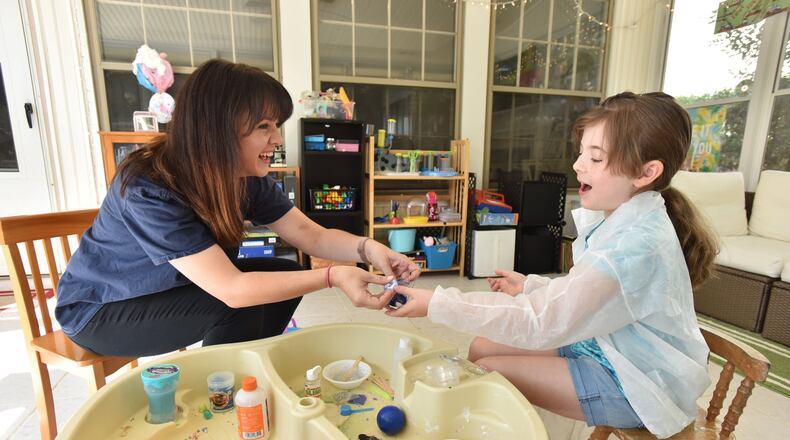 September 24, 2019 Marietta - Kelly Hobby and her 8-year-old daughter Chloe make slime together at their Marietta home on Tuesday, September 24, 2019. The Marietta City Schools System in January will begin an initiative providing free child care for its employees. Kelly Hobby, a teacher at Al Burruss Elementary School in Marietta, is an educator who has signed up for the school system’s initiative to provide free child care for its employees. (Hyosub Shin / Hyosub.Shin@ajc.com)