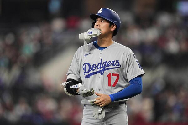 Los Angeles Dodgers' Shohei Ohtani walks to the dugout after grounding out to first in the fifth inning of a baseball game against the Texas Rangers in Arlington, Texas, Sunday, April 20, 2025. (AP Photo/Tony Gutierrez)