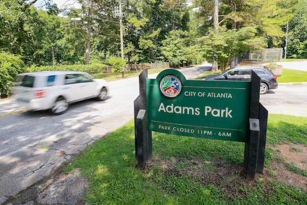 A car drives by one of the entrances to Adams Park, where the City of Atlanta plans to create new trails and work toward most Atlantans being within 10-minute access of a park. (Miguel Martinez/AJC)