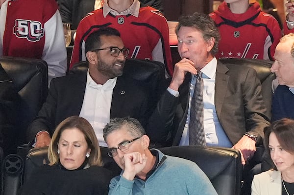 FBI director is Kash Patel, left, tallking with former NHL player Wayne Gretzky, right, during the first period of an NHL hockey game between the Washington Capitals and Chicago Blackhawks, Friday, April 4, 2025, in Washington. (AP Photo/Mark Schiefelbein)