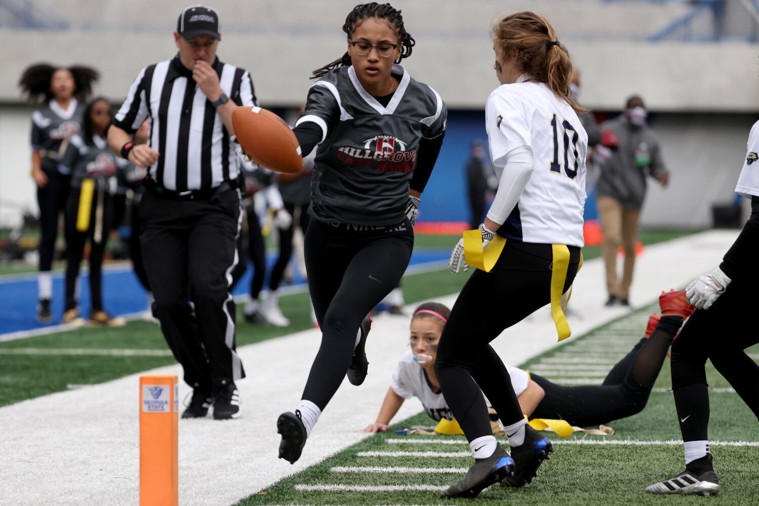 Hillgrove running back Jasmine Blackmon is stopped for a short gain in the first half against West Forsyth during the Class 6A-7A Flag Football championship at Center Parc Stadium Monday, December 28, 2020 in Atlanta, Ga.. JASON GETZ FOR THE ATLANTA JOURNAL-CONSTITUTION