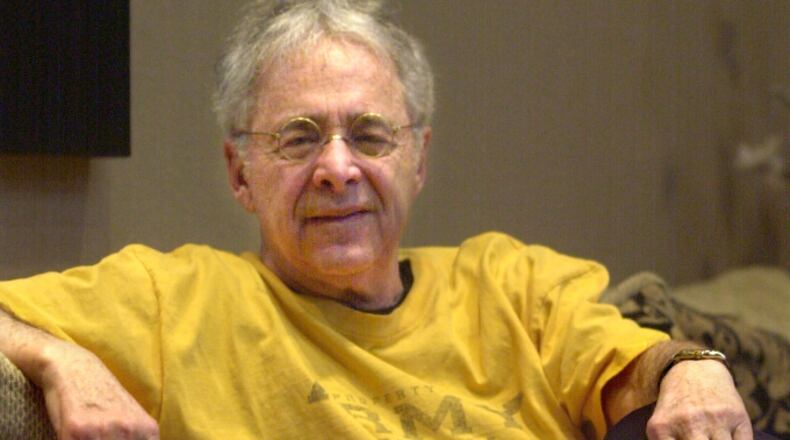 FILE - In this Dec. 20, 2002, file photo, Chuck Barris, the man behind TV's "The Dating Game," poses in the lobby of his apartment in New York. Game show impresario Barris has died at 87. Barris, the madcap producer of "The Gong Show" and "The Dating Game," died of natural causes Tuesday afternoon, March 21, 2017, at his home in Palisades, New York. (AP Photo/Bebeto Matthews, File)