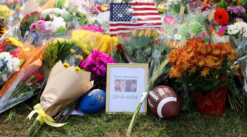 A memorial with images of the those killed are, from left, Richard "Ricky" Aspinwall, Cristina Irimie, Mason Schermerhorn and Christian Angulo at a memorial at Apalachee High School on Friday in Winder. (Jason Getz/The Atlanta Journal-Constitution)