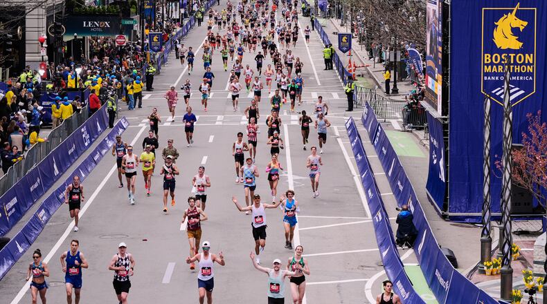 Runners stride down Boylston Street while approaching the finish line of the Boston Marathon, Monday, April 20, 2026, in Boston. (AP Photo/Charles Krupa)