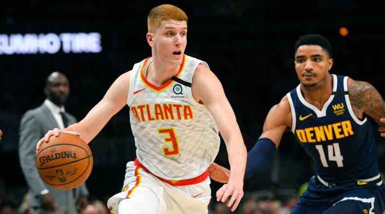 Hawks guard Kevin Huerter (3) drives against Nuggets guard Gary Harris during the first half of Monday's game at State Farm Arena. (AP Photo/John Amis)
