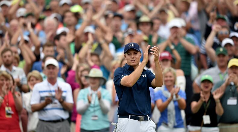 Jordan Spieth, 21, completes the first wire-to-wire Masters victory in 39 years and shows his own appreciation. (BRANT SANDERLIN/BSANDERLIN@AJC.COM)