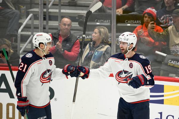 Columbus Blue Jackets center Adam Fantilli (19) celebrates his goal with left wing James van Riemsdyk (21) during the third period of an NHL hockey game against the Washington Capitals, Sunday, April 13, 2025, in Washington. (AP Photo/Nick Wass)