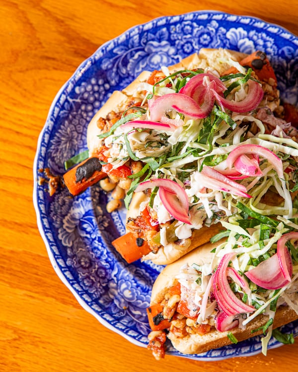 Marinated carrots taste surprisingly similar to hot dogs, especially when loaded with chili, slaw and pickled onions. (Aaliyah Man for The Atlanta Journal-Constitution/food styling by Michele Tomkins)