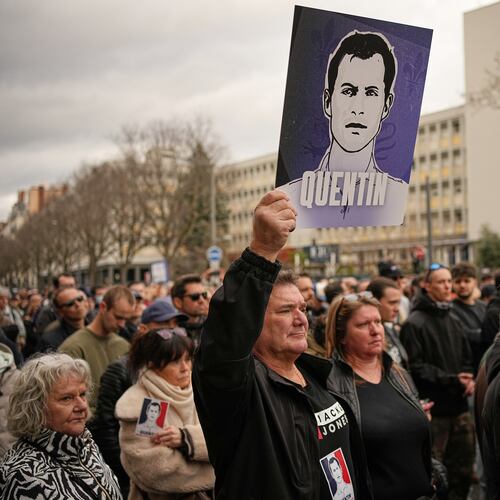 A man hold placard of the killed student as he takes part in a march in Lyon, France, Saturday, Feb. 21, 2026, to pay tribute to Quentin Deranque, a 23-year-old nationalist activist who died from a beating after a clash between far-left and far-right supporters. (AP Photo/Laurent Cipriani)