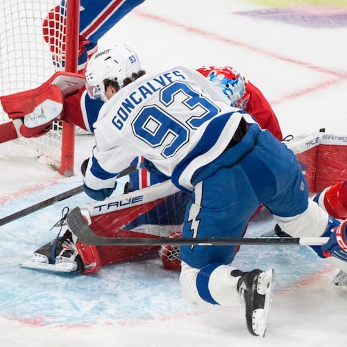 Tampa Bay Lightning's Gage Goncalves (93) scores against Montreal Canadiens goaltender Jakub Dobes, bottom, during overtime of Game 6 in the first round of an NHL hockey Stanley Cup playoff series in Montreal, Friday, May 1, 2026. (Christinne Muschi/The Canadian Press via AP)