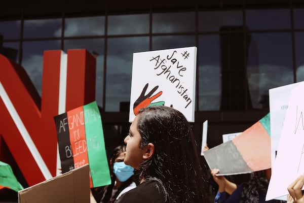 Demonstrators raise signs in downtown Atlanta on Sunday, Aug. 15, 2021, to bring attention to the situation in Afghanistan.
