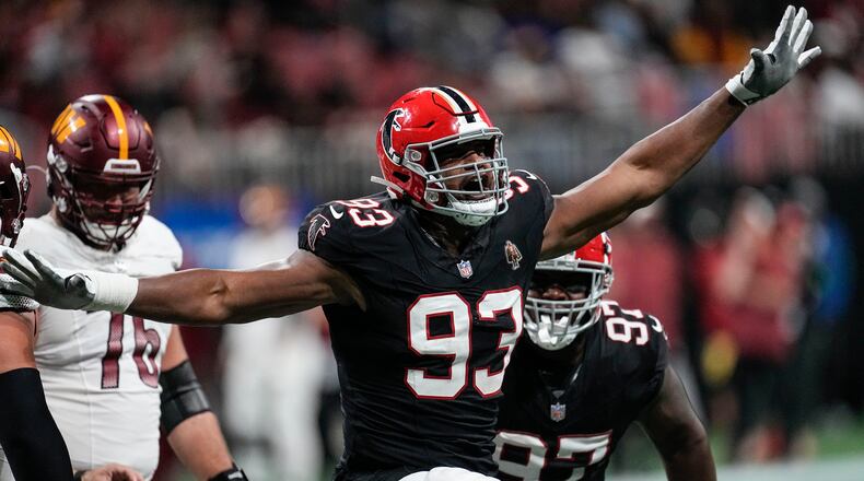Atlanta Falcons defensive tackle Calais Campbell (93) celebrates his 100th career quarterback sack against the Washington Commanders during the first half of an NFL football game, Sunday, Oct. 15, 2023, in Atlanta. (AP Photo/John Bazemore)