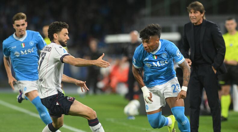 Bologna's Joao Pedro, second left, challenges for the ball with Napoli's Alisson Santos during the Italian Serie A soccer match between Napoli and Bologna in Naples, Italy, Monday, May 11, 2026. (Alessandro Garofalo/LaPresse via AP)