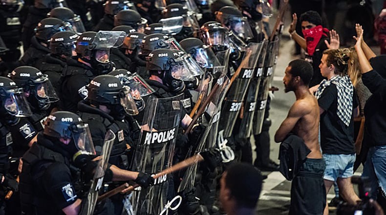 CHARLOTTE, NC - SEPTEMBER 21: Police officers in riot gear approach demonstrators September 21, 2016 in downtown Charlotte, NC. Protests in Charlotte began on Tuesday in response to the fatal shooting of 43-year-old Keith Lamont Scott at an apartment complex near UNC Charlotte. (Photo by Sean Rayford/Getty Images)