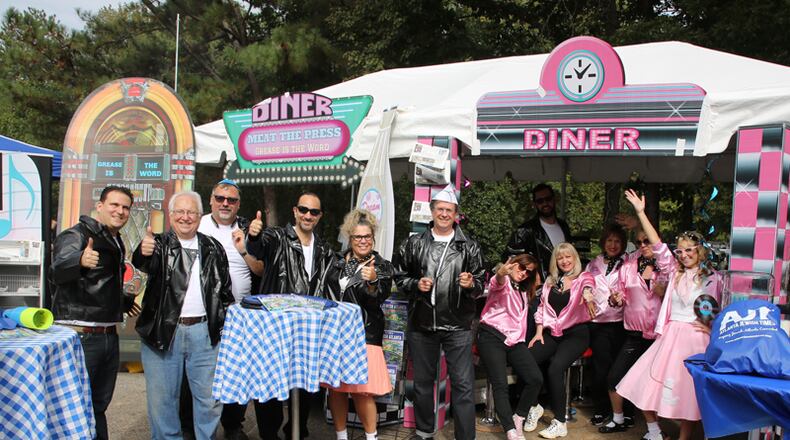 “Grease” is the word for the Atlanta Jewish Times barbecue team led by Michael Morris (center, in white hat) at the 2017 Atlanta Kosher BBQ Festival. This year’s festival, Sunday, Oct. 21, is moving to City Springs in Sandy Springs. ERIC BERN / ATLANTA KOSHER BBQ FESTIVAL
