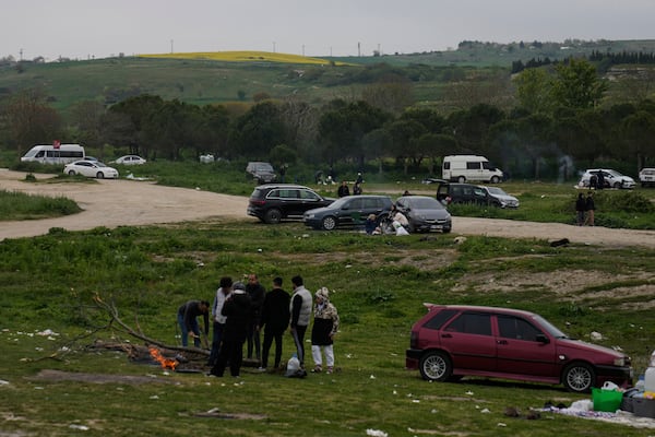 People gather outdoors away from urban areas following an earthquake shock with a preliminary magnitude of 6.2, in Istanbul, Turkey, Wednesday, April 23, 2025. (AP Photo/Khalil Hamra)