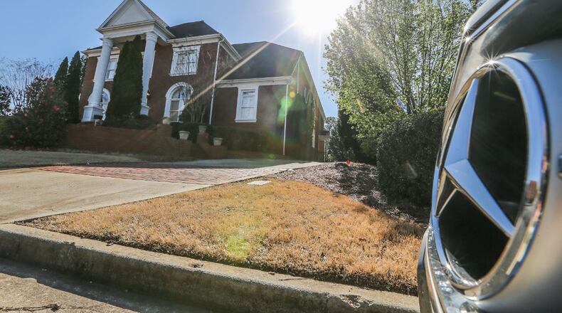 This house in Sandy Springs is where police say a man held eight women against their will. JOHN SPINK / JSPINK@AJC.COM