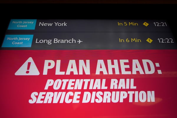 An electronic display advises commuters of potential NJ Transit service disruptions at the Secaucus Junction station in Secaucus, N.J., Wednesday, May 14, 2025. (AP Photo/Seth Wenig)