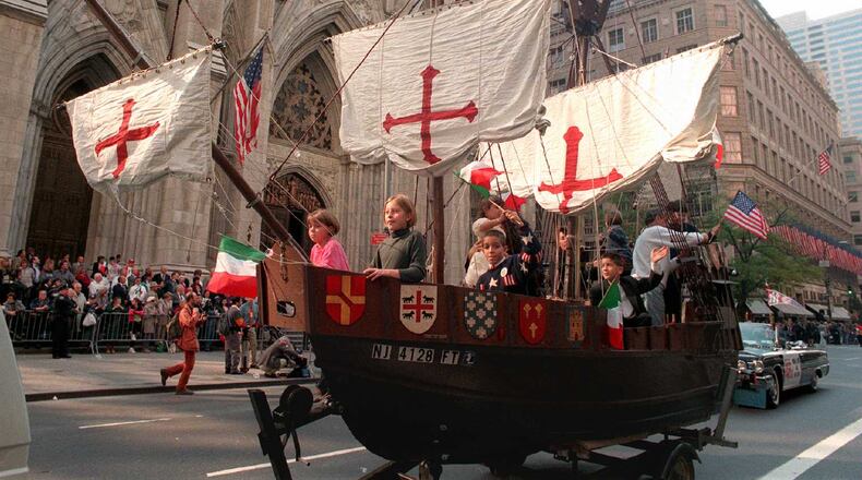 A model of the 'Santa Maria,' one of Christopher Columbus' three ships, is pulled up New York's Fifth Ave. with children aboard Monday, Oct. 14, 1996, in front of St. Patrick's Cathedral during the 56th Columbus Day Parade. (AP Photo/Marty Lederhandler)