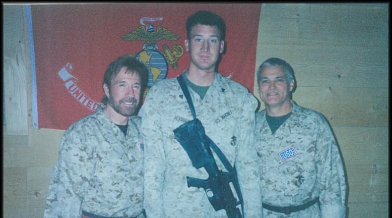 Drew DeVoursney, center, a Marine veteran from Atlanta who served in Iraq, was killed with his Canadian girlfriend recently in Belize. Police say theft was not a motive. He was able to meet actor and martial artist Chuck Norris, left, while serving in the Marines.