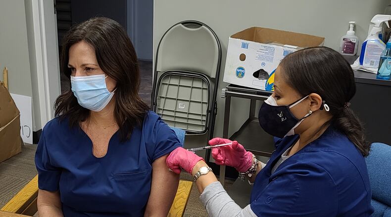 Rising Starr Middle school nurse Tiffany Blair receives the Moderna COVID-19 vaccination from a nurse at the Fayette County Health Department earlier this month. Across the state, family physicians, traveling nurses, home health staff and practitioners not affiliated with a hospital have had problems getting vaccinated, even though they may be the first point of contact of those with COVID-19.